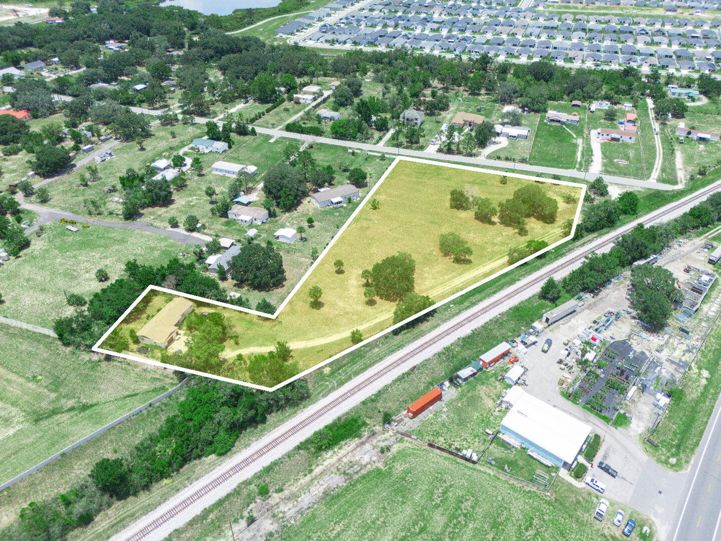 Angled aerial of the parcel with new subdivisions behind it