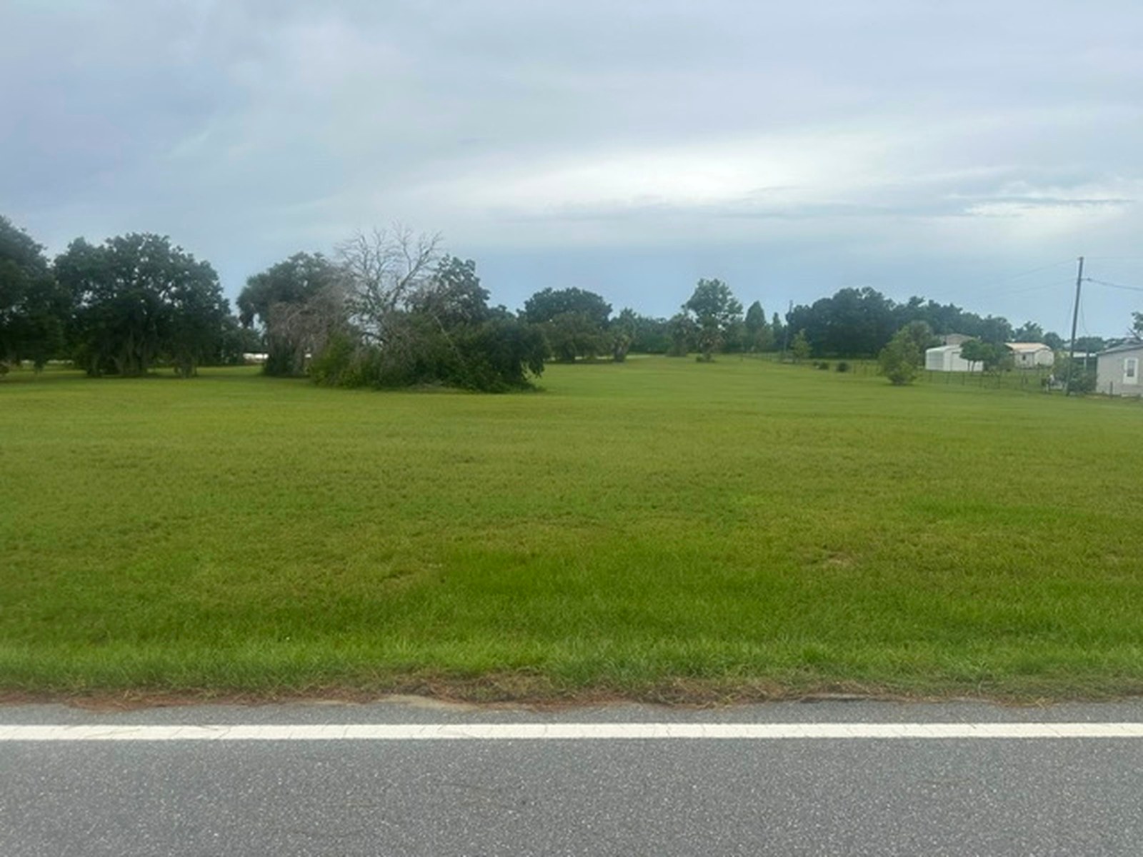 Street-level view across the parcel toward neighboring homes